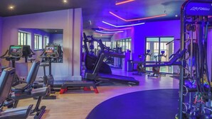 A gym with treadmills, elliptical machines, and weightlifting equipment. - Forest Pines Spa and Golf Resort (Brigg)