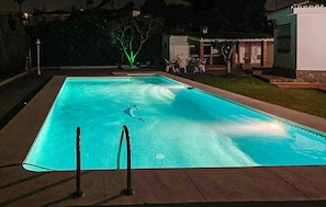 A rectangular swimming pool with a clear blue water surface, surrounded by a paved deck. - Amazing home in Malaga (Malaga)