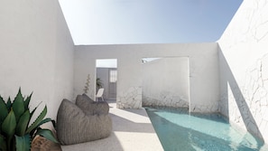 A modern spa area with a pool, seating, and a view of the sky. - Anome Hotel (Mykonos)