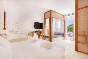 A modern hotel room with a large bed, a TV, a balcony, and a view of the outdoors. - Anome Hotel (Mykonos)