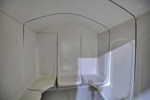 A modern, minimalist room with a curved ceiling and a central column. - City Stay Hotel Expo Center Sharjah (Sharjah)