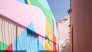 A corridor with a colorful mural on the wall and a patterned floor. - Zen Zone Boutique Riad & Spa (Marrakech)