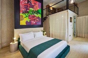 A modern bedroom with a large bed, a painting above the bed, a staircase, and a view of the outdoors. - Zen Zone Boutique Riad & Spa (Marrakech)