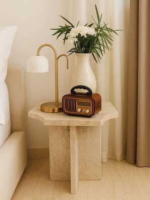 A small bedside table with a lamp, radio, and vase with flowers. - Zen Zone Boutique Riad & Spa (Marrakech)