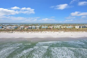 A coastal view with beachfront properties, sandy beach, and ocean waves. - Oceanfront 2BD/2BA w/Parking, Wi-Fi, Work Space, Beach Access & Community Pool (St. Augustine)