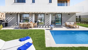 A modern two-story house with a swimming pool, outdoor seating, and a barbecue area. - Villa Oronella with Saltwater Pool, Premium Comfort & Elegant Design (Puigderros (Llucmajor))