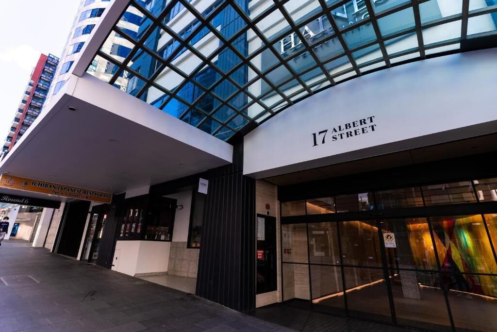 A modern building with a glass facade and a sign for '17 Albert Street.'