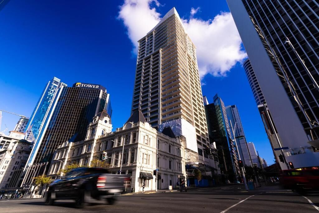 A cityscape with modern and historic buildings, including a prominent tower labeled 'TOWER.'