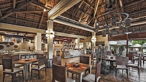 A spacious restaurant with high ceilings and a bar area. - Elegant 3-Bedroom Villa / Sea View & Bel Ombre Setting (Bel Ombre)