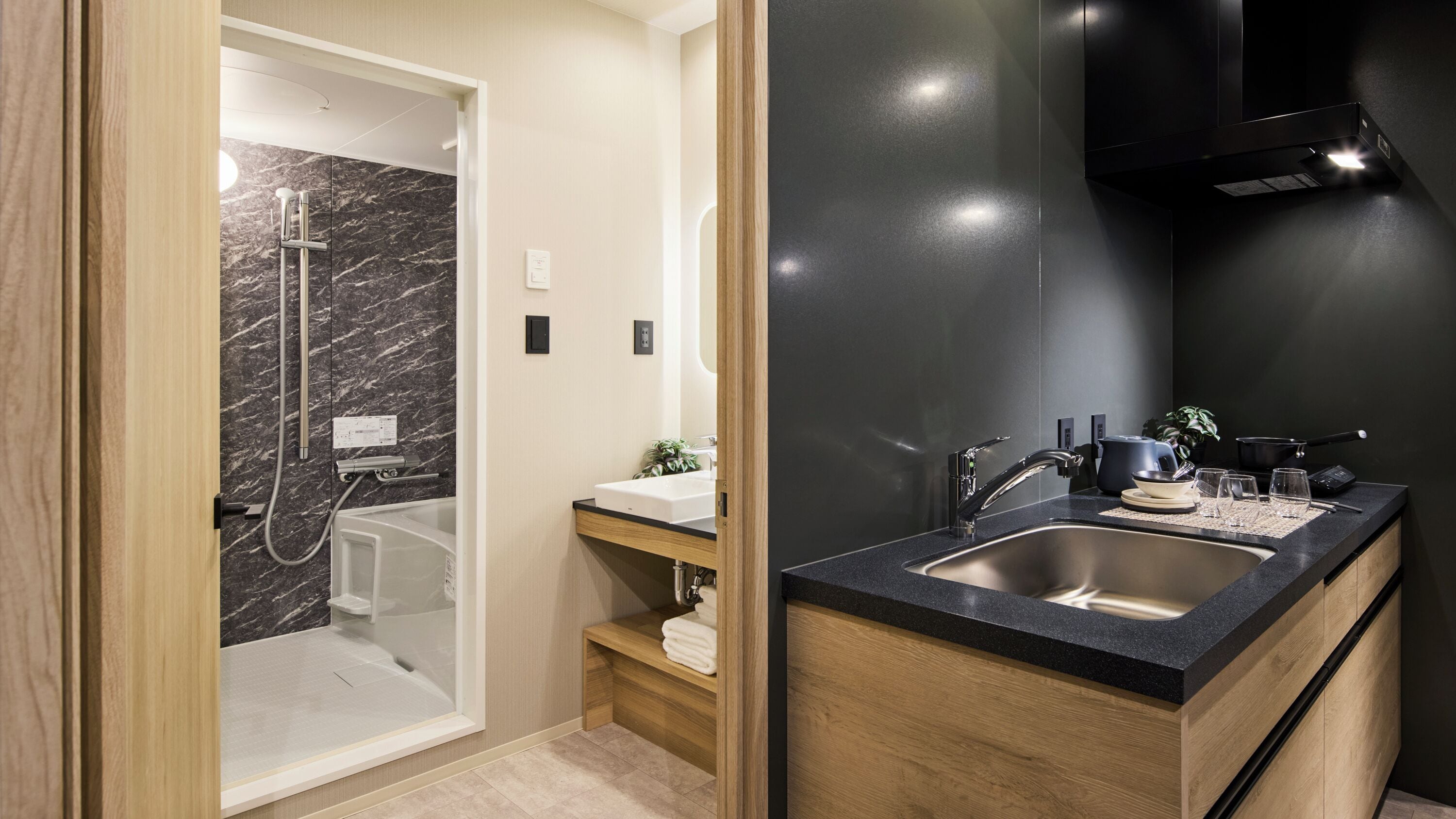 A modern bathroom with a shower, sink, and wooden cabinetry.