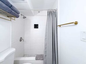 Shower, hair dryer, towels, shampoo