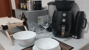 A kitchen counter with a coffee maker, a kettle, and a microwave. - Suite Da Praia Ar-conditioned (Rio de Janeiro)