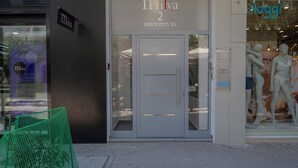 A storefront with a sign reading 'Milva 2 MEROPIDOS Str.' and mannequins in the window. - Milva Apartments (Kos)