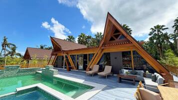 A resort with a swimming pool, lounge area, and wooden architecture.