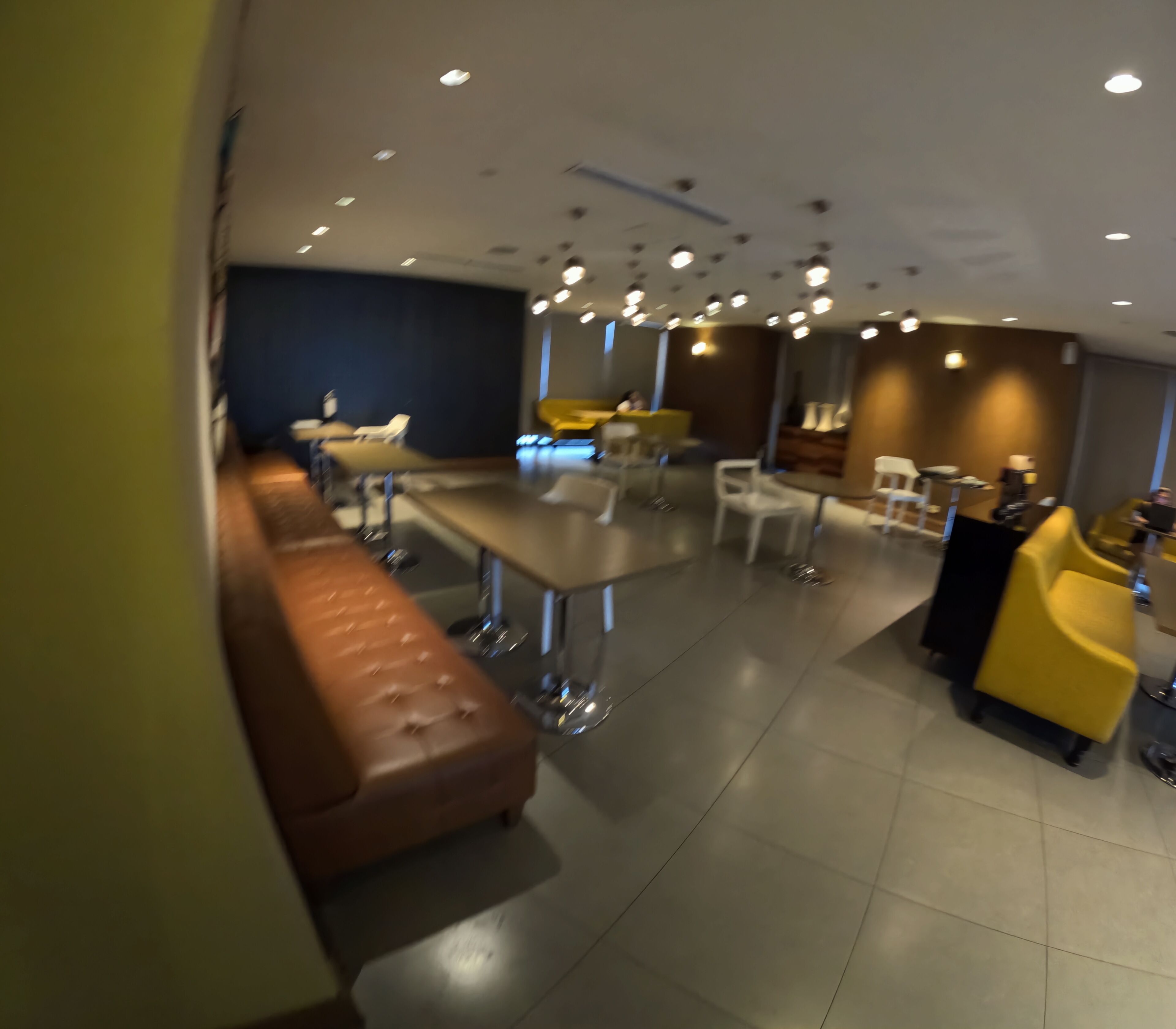 A modern interior with a bar area, seating, and a dark accent wall.