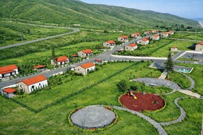 A residential area with houses, roads, and a playground. - Sugovushan Hotel and Cottages (Sugovushan)