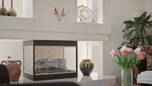 A room with a fireplace, a vase with flowers, and a plant. - Vegas Grand Villa - 5BR, Pool, Putting Green (Las Vegas)