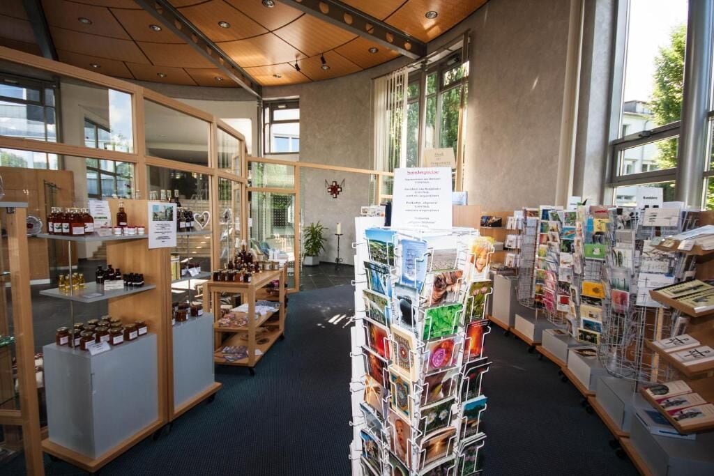A bookstore with shelves of books and a display of postcards.