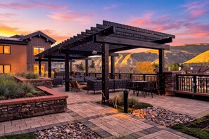 A patio area with outdoor seating, a pergola, and a view of mountains. - Condo + Ski Shuttle + Pool + Spa Access | Mountain Dream at Frontgate (Avon)