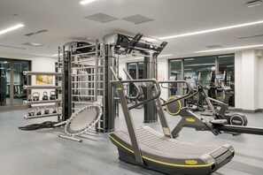 A gym with exercise equipment, a treadmill, and a weight rack. - Condo + Ski Shuttle + Pool + Spa Access | Mountain Dream at Frontgate (Avon)