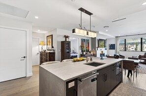 A modern kitchen with a large island, built-in appliances, and a pendant light. - Condo + Ski Shuttle + Pool + Spa Access | Mountain Dream at Frontgate (Avon)