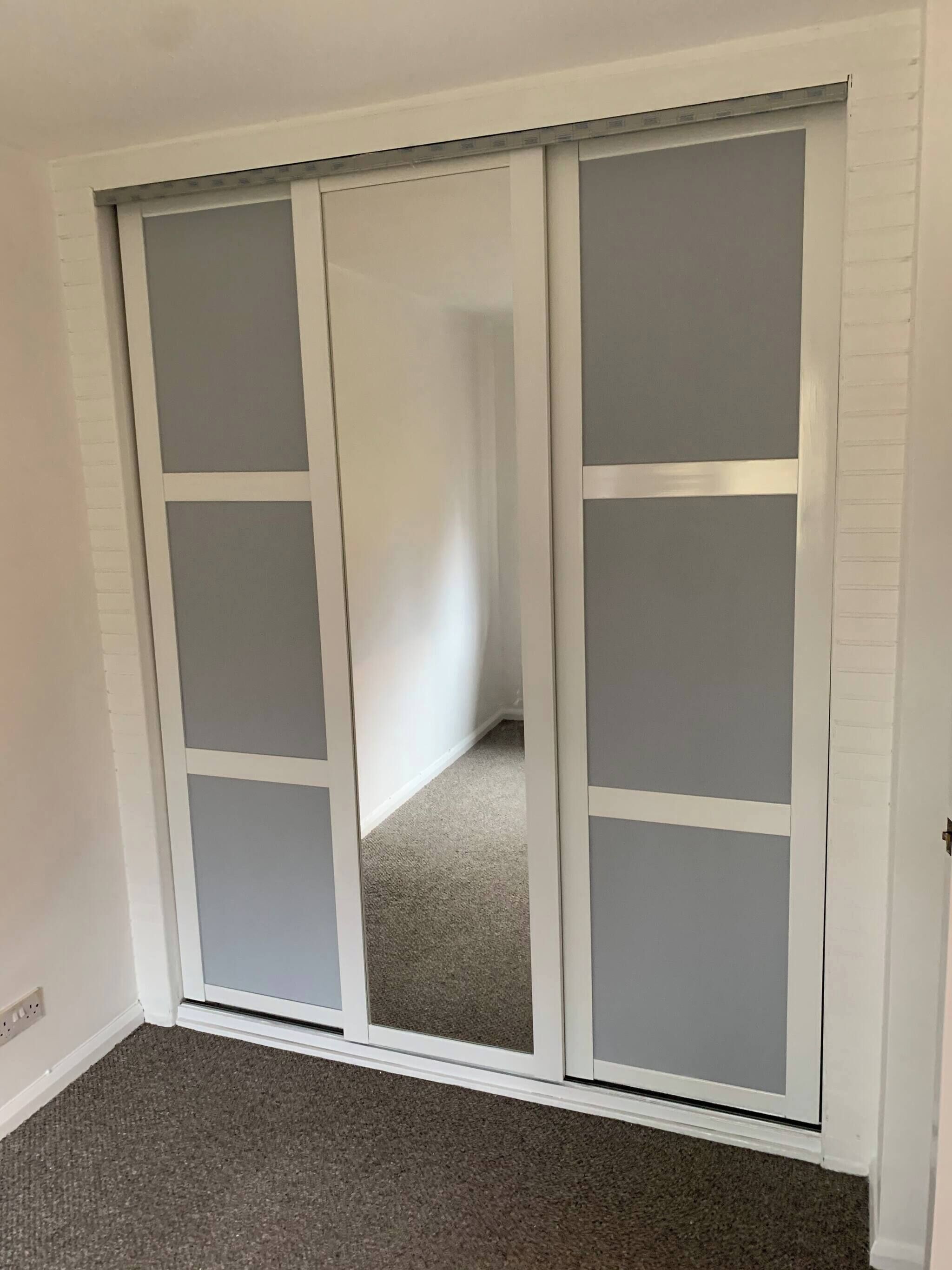 A room with a sliding door leading to a hallway.