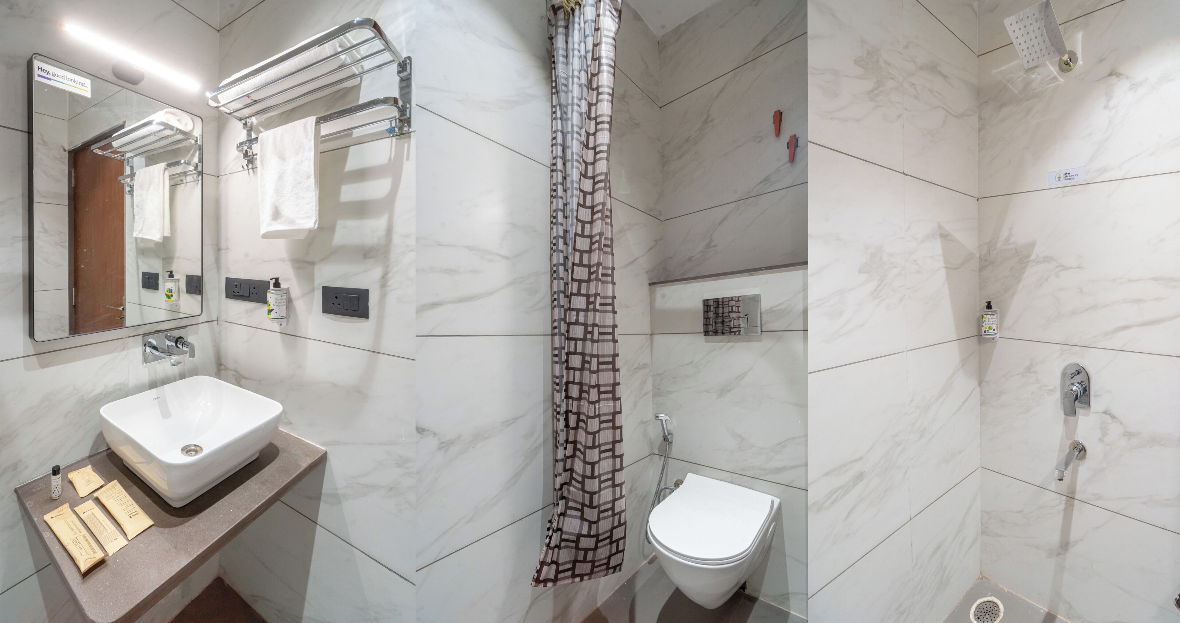 Ein Badezimmer mit Marmorwaschtisch, Toilette, Dusche mit Glastür und Handtuchhalter.