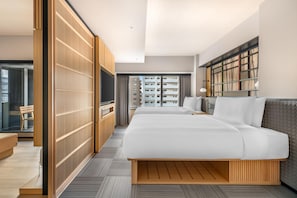 A modern hotel room with a large bed, wooden wardrobe, and a view of high-rise buildings. - Hilton Grand Vacations Club Tradimo Kyoto Gojo (Kyoto)