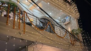 The exterior of Shri Award Hotel with string lights and garlands. - Shri Awadh Hotel (Sitamarhi)