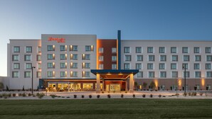 A large, multi-story hotel with a prominent entrance, multiple windows, and a well-lit facade. - Hampton Inn by Hilton Grand Island Medical Center (Grand Island)
