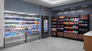 A grocery store interior with refrigerated snack and fuel up sections, and shelves stocked with various snacks and treats. - Hampton Inn by Hilton Grand Island Medical Center (Grand Island)