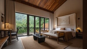 A modern bedroom with a large window, a bed, a sofa, a table, and a chair. - Xishan Cloister (Chengdu)