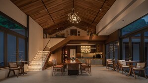 A spacious interior with a dining area, a staircase, and a kitchen. - Xishan Cloister (Chengdu)