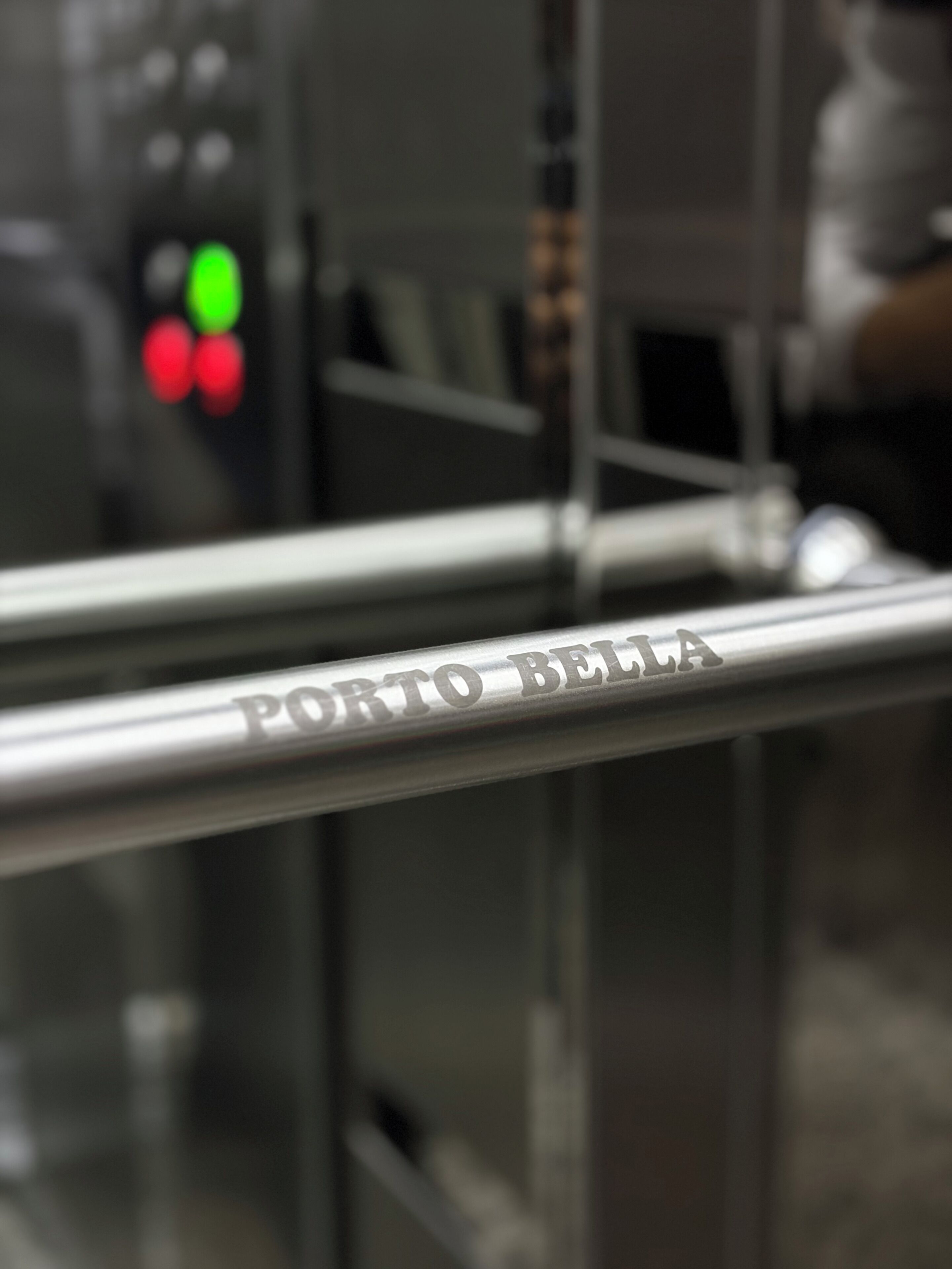 A metallic bar with 'PORTO BELLA' engraved on it.