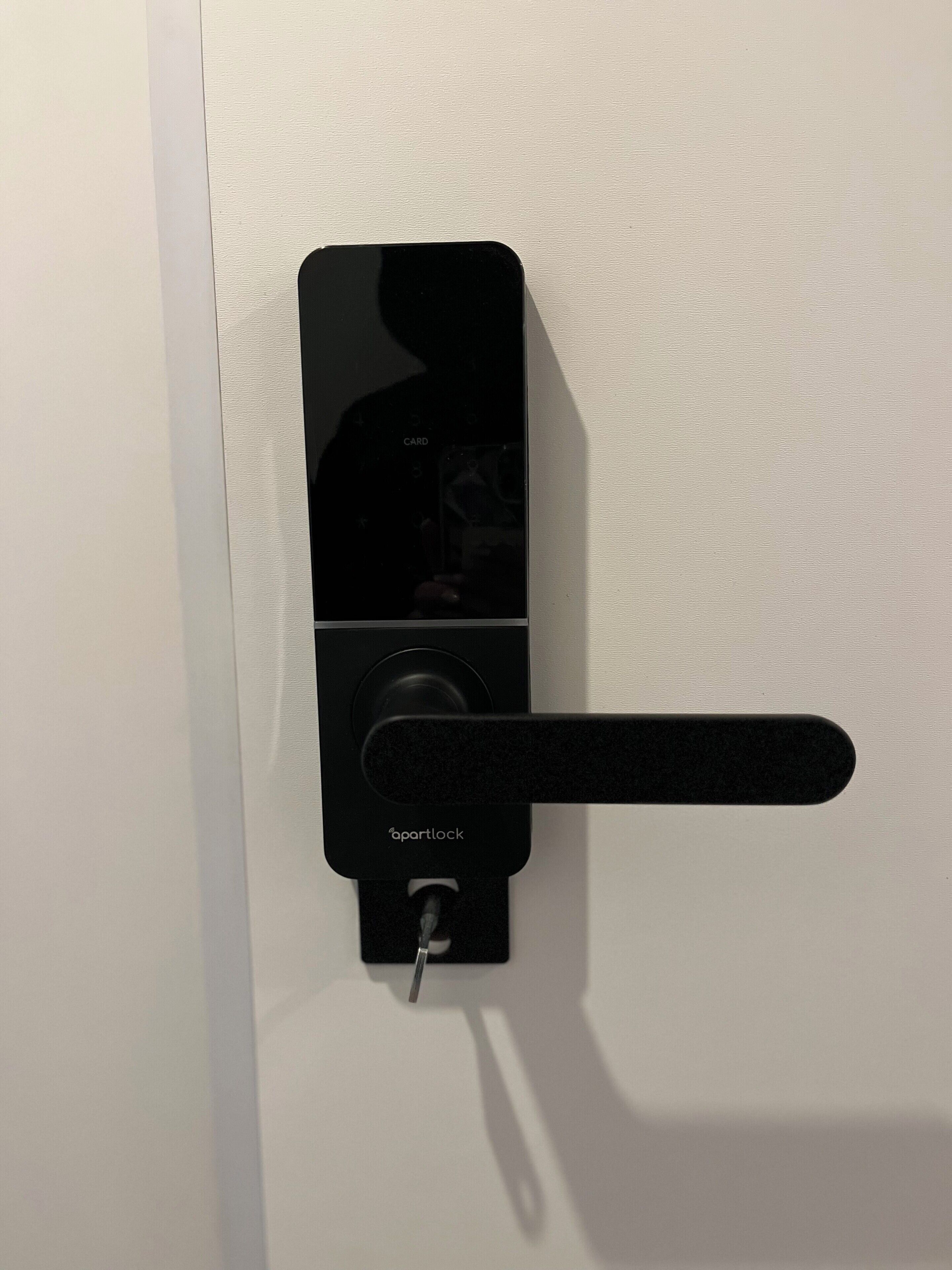A modern door lock with a keyhole and a handle.