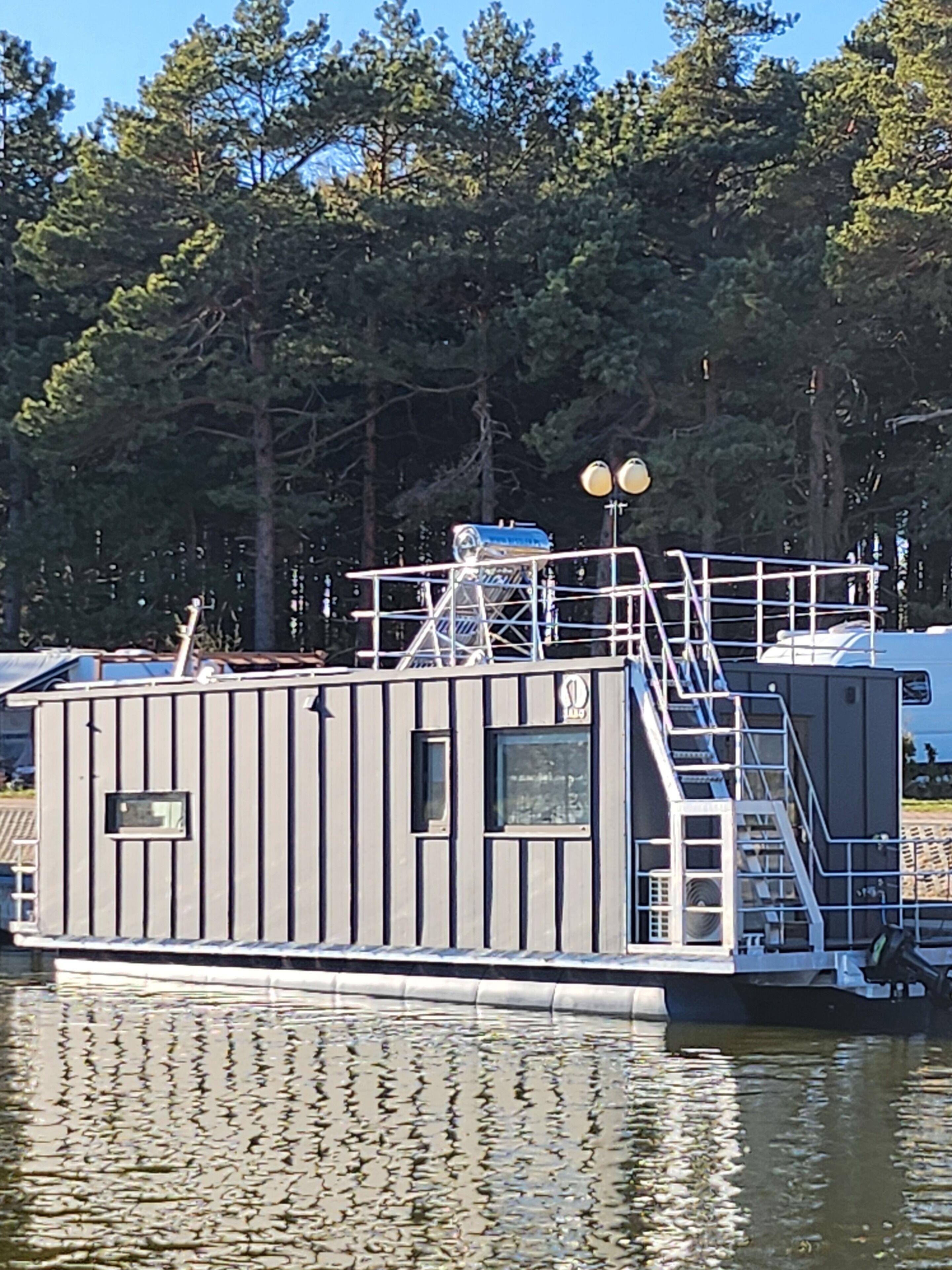 A stationary boat with a cabin, a staircase, and a small window.