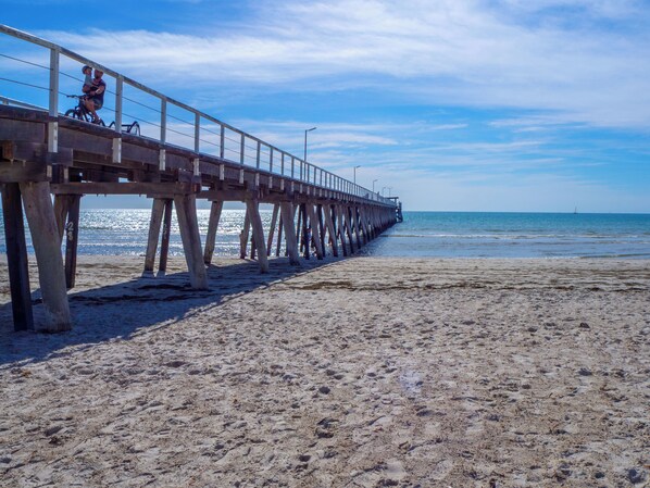 A pier extending into the sea with a sandy beach in the foreground. - 2BR Seaside Retreat in Largs North (Largs North)