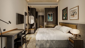 A hotel room with a bed, desk, chair, and a mirror. - Veriu Richmond (Richmond)