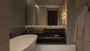 A modern bathroom with a freestanding bathtub, a vanity with a mirror, and a towel rack. - Veriu Richmond (Richmond)