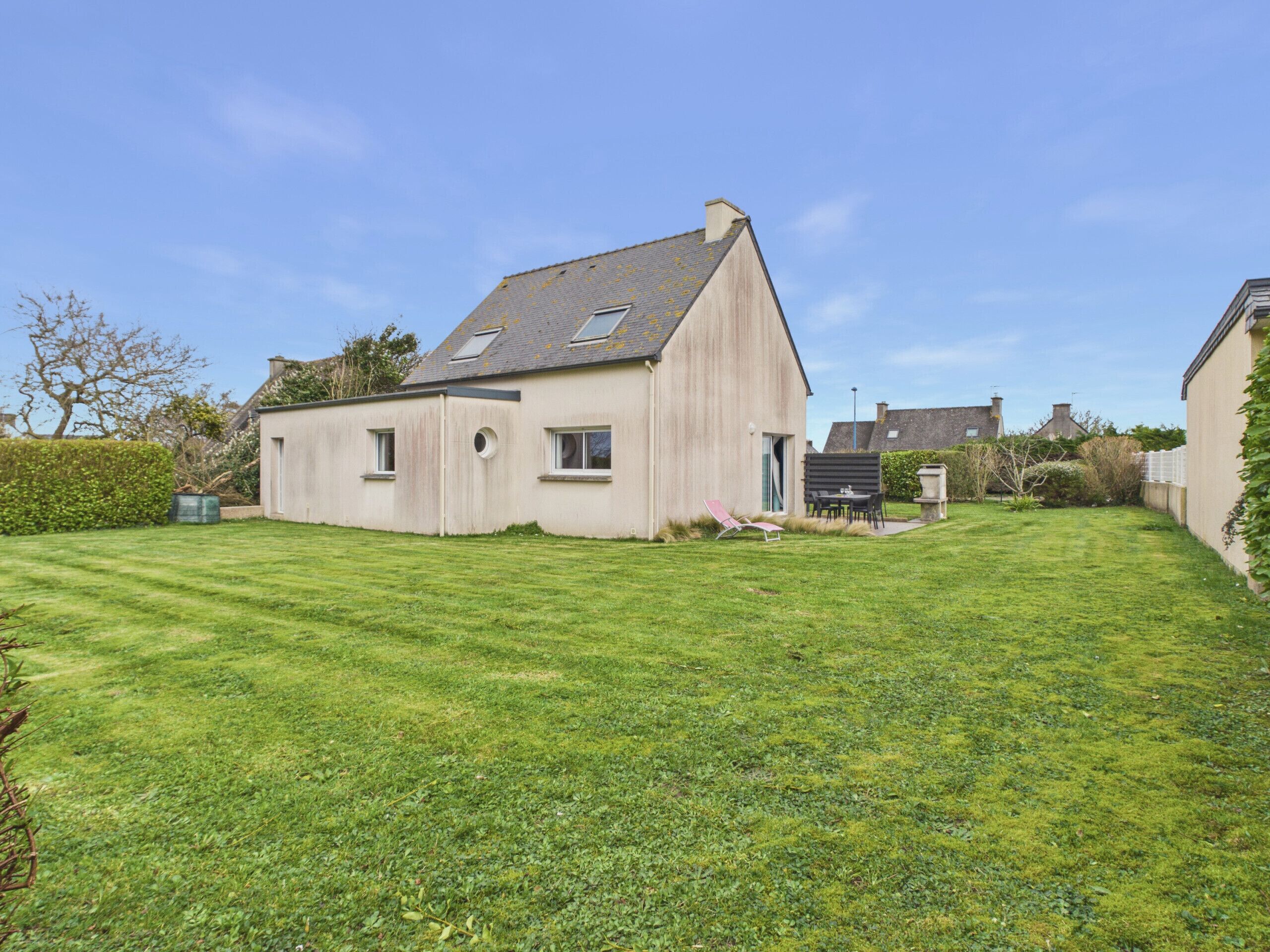 A single-story house with a sloped roof, a small front porch, and a well-maintained lawn.