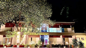 A building with a sign reading 'DEVORA RESORT' at night, featuring a staircase leading to a covered entrance. - Devora Resort (Rishikesh)