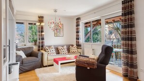 Ein modernes Wohnzimmer mit einer Couch, einem Sessel und einem Couchtisch.