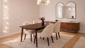 A dining area with a wooden table, white chairs, a vase with red flowers, a wooden cabinet, and two wall-mounted mirrors. - Prime Covent Garden Stay - Central, Calm & Stylish (London)