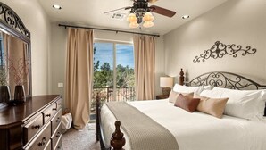 A bedroom with a bed, dresser, ceiling fan, and a view through the window. - Sedona Getaway Sedona! 2-King, Hiking, Views, Pets! (Sedona)