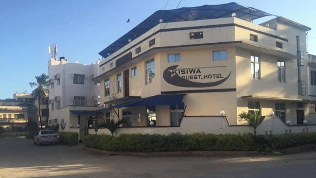 A modern building with a sign reading 'Kisiwa Guest Hotel.' - Kisiwa Boutique Hotel Mombasa (Mombasa)