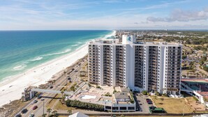 A high-rise hotel with multiple balconies, a beach view, and a parking area. - Gulf-Front Luxury | Surfside 11th Floor | #1109 | 2B/2Ba (Miramar Beach)