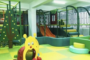 A play area with a slide, climbing structures, and soft play surfaces. - Stylish Lavington Retreat | Pool, Views & CBD Access (Nairobi)
