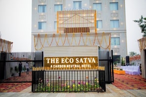 A hotel entrance with a sign reading 'The Eco Satva: A Carbon Neutral Hotel.' - Eco Satva Ayodhya - Vegetarian with all Options (Ayodhya)