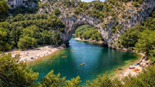 A natural arch over a clear blue river with a beach and kayaks. - Exceptional villa with panoramic view and heated pool (Sampzon)