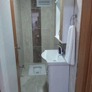 Shower, hair dryer, slippers, towels